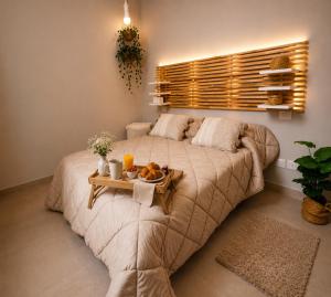 a bedroom with a bed with a tray of food on it at Maison La Reggia in Caserta +15 photos