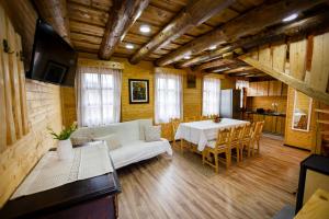 a living room with a couch and a table at Székelyföld,Siklódi Kő Vendégház Szénatároló in Şiclod