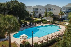 an overhead view of a swimming pool with lounge chairs at Ocean Ridge Resort 1BR Apartment in Edisto Island