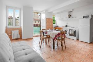 a kitchen and dining room with a table and chairs at Boni in Saint-Julien-Molin-Molette +12 photos