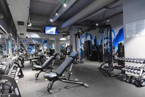a gym with treadmills and machines in a room at Hotel Moldova in Iaşi