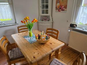 a wooden table with a basket of flowers on it at Dietlinds Apartment in Ober-Nauses