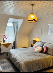 a bedroom with a large bed with a large window at Historisches Winzerhaus Lieser in Lieser
