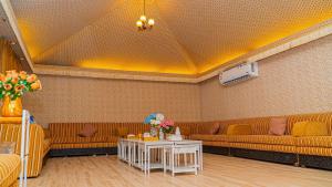 a living room with couches and a table with flowers at استراحة ليال in Jeddah