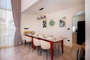 a dining room with a table and chairs at Luma & Malta PoolVilla Cha-am in Sathani Nong Ta Phot