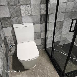a bathroom with a white toilet in a stall at Aires de Benatae in Benatae +9 photos