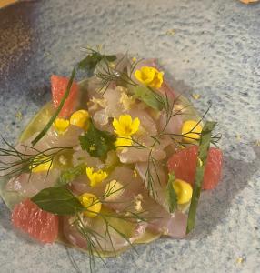 a plate of food with vegetables and flowers on it at Les Trois Soleils in Saint-Céré +10 photos