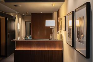 a room with a counter with a lamp and pictures at Speronari Suites in Milan +90 photos