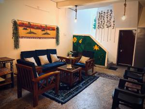 a living room with a couch and chairs and a table at Deodar Commune in Visakhapatnam +31 photos