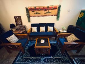 a living room with couches and a coffee table at Deodar Commune in Visakhapatnam