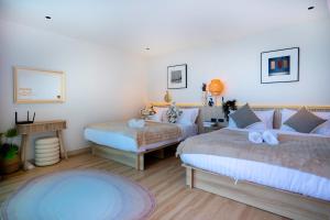 a bedroom with two beds and a table at Luma & Malta PoolVilla Cha-am in Sathani Nong Ta Phot +79 photos