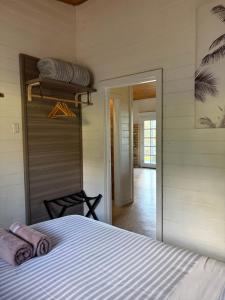 a bedroom with a bed with towels on it at The Bloom Farm Cottage in Carrajung South