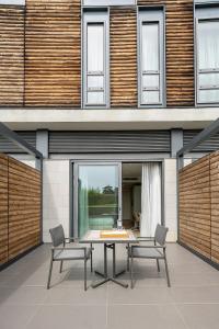 a dining room with a table and chairs in front of a building at MOVE Hotels Venezia Nord in Mogliano Veneto