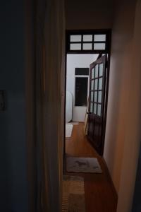 a hallway with a door and a mirror in a room at Pawseas Homestay in Danang +2 photos