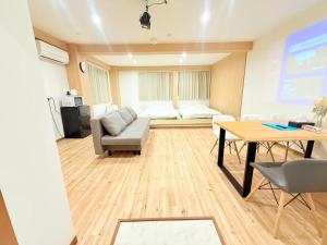 a living room with a couch and a table at クリスタルSky tree Hotel in Tokyo