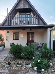 a house with a balcony and a patio at Tücsi lak in Szigetszentmárton