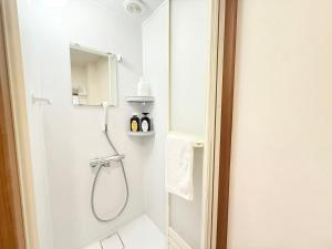a white bathroom with a shower and a mirror at クリスタルSky tree Hotel in Tokyo +45 photos