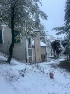 a house in a yard covered in snow at Agriturismo Relais Kloe in Castel Boglione