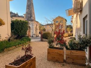 two wooden boxes with plants in them on a street at Appartement avec jacuzzi et vue sur Pyramide in Vienne