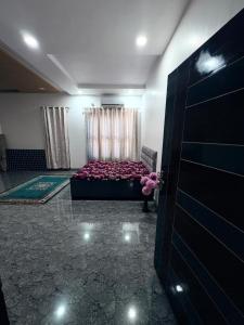a living room with a bed and a door at NaPrer Homes in Dehradun