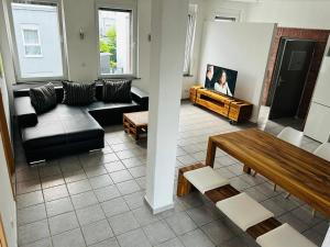 a living room with a couch and a table at Loft im Fabrikstil mit 2 eigenen Schlafzimmern mit Wlan und Parkplatz in Groß-Umstadt