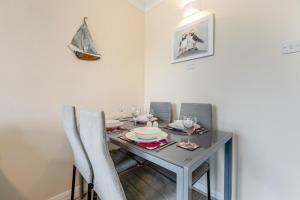 a dining room with a grey table and chairs at 2 Bed in Bideford oc-rives in Bideford +10 photos