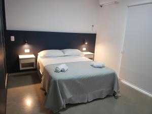 a bedroom with a bed with two towels on it at Departamentos Felice in Santa Rosa