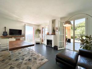 a living room with a couch and a fireplace at COGO, Premium Private Villa Vista Mare in Cogorno