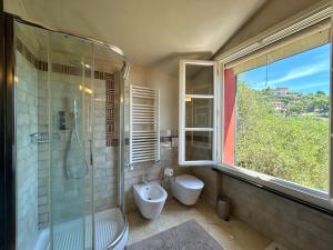 a bathroom with a shower and a toilet and a sink at COGO, Premium Private Villa Vista Mare in Cogorno +67 photos