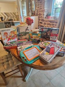 a table with books and other items on it at Ker Adèle, longère cosy au cœur d'un bois in Ploërdut +28 photos