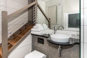 a bathroom with a sink and a staircase at Drakes Hotel in Brighton & Hove