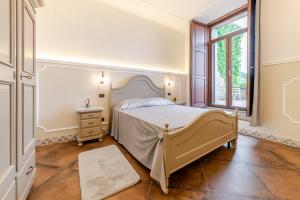 a bedroom with a large bed and a window at Ospitalità Deluxe Castello Vassallo in Stella Cilento +91 photos