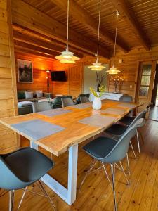 a large wooden table in a room with chairs at Finnische Blockhäuser in Gartow
