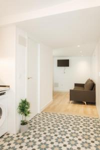 a living room with a couch and a tv at Trepat Harbor's Light in Villajoyosa
