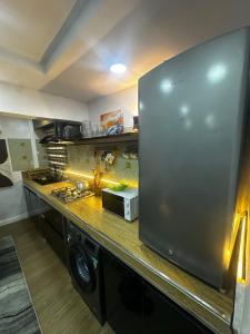 a kitchen with a stainless steel refrigerator at Hope Apartments Surulere in Lagos