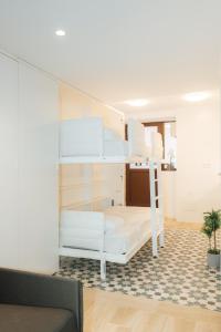 a white bunk bed in a room with a couch at Trepat Harbor's Light in Villajoyosa