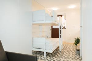 a room with a bunk bed and a couch at Trepat Harbor's Light in Villajoyosa +17 photos