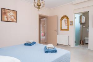 a bedroom with a bed with blue towels on it at Celeste Sea View Home with Jacuzzi and BBQ in Psalidi
