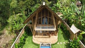an aerial view of a bamboo house with a pool at Bamboo Garden Villa Sidemen - Private Pool & Nature View in Selat