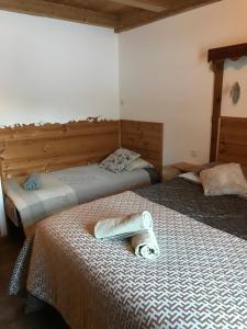 two beds in a room with towels on them at Ferme de la Clarée in Névache