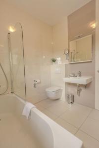 a bathroom with a tub and a toilet and a sink at Etno Garden Exclusive in Plitvička Jezera
