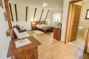 a large room with a bed and a bathroom at Etno Garden Exclusive in Plitvička Jezera