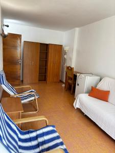 a living room with a bed and chairs in it at Casa Scriitorilor in Olimp