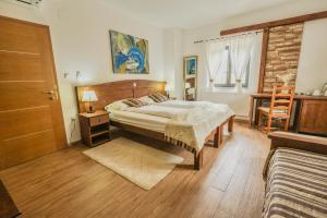 a bedroom with a bed and a chair in it at Etno Garden Exclusive in Plitvička Jezera +83 photos