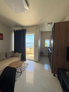 a living room with a couch and a view of the ocean at Villa Luna Maris in Starigrad