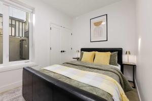 a bedroom with a bed and a window at Newly Built Suite-West Coquitlam in Coquitlam