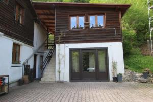 a house with a black door and a balcony at Ostoja in Ojców
