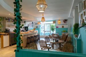 a restaurant with tables and chairs and a bar at Cactus by Arenas in Salinas