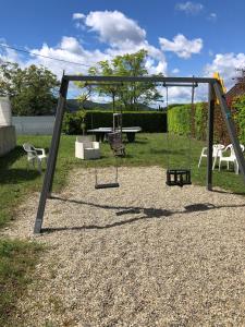 a playground with a swing set and a table at Mobilhome avec piscine in Ruoms
