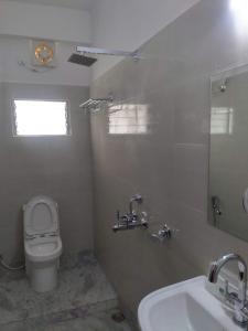 a bathroom with a toilet and a sink at Boroli in Shaugaon +16 photos